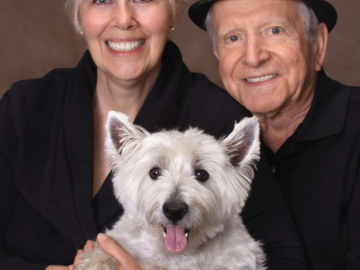 A portrait of a couple with their dog
