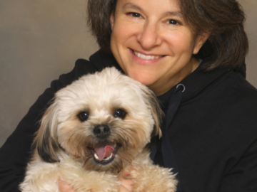 A portrait of a woman hugging her dog
