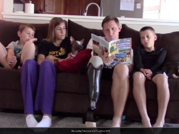 Wounded Warrior Ben reading Pink's book to his children, Pink and Toaster on couch!