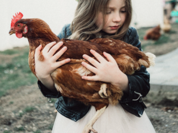 Young girl with her favorite hen