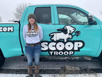 Scoop Troop Employee standing in front of a Scoop Troop branded truck. 