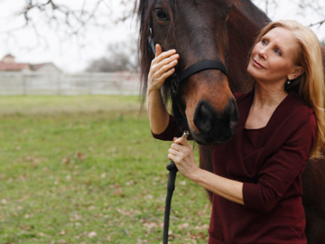 Nancy volunteering with rescue horse with White Bridle Humane Society