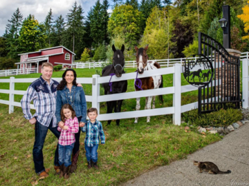 A Family with their horses and cat on their ranch!