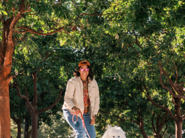skateboarding parent and their samoyed in the city