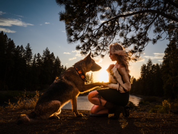 Woman with her German Shepherd at sunset.