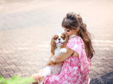 Photo of Woman holding a Cavalier King Charles Spaniel